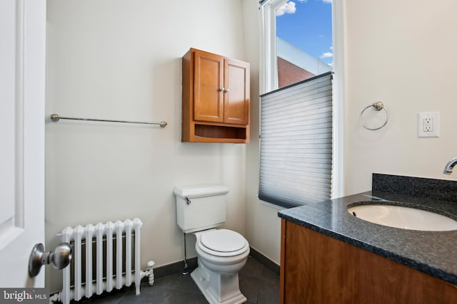 1240 Girard St NW, Washington, DC 20009 - half bathroom featuring radiator, vanity, and tile patterned flooring
