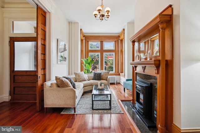 1240 Girard St NW, Washington, DC 20009 - living area with radiator heating unit, a chandelier, dark wood-style flooring, and built in features