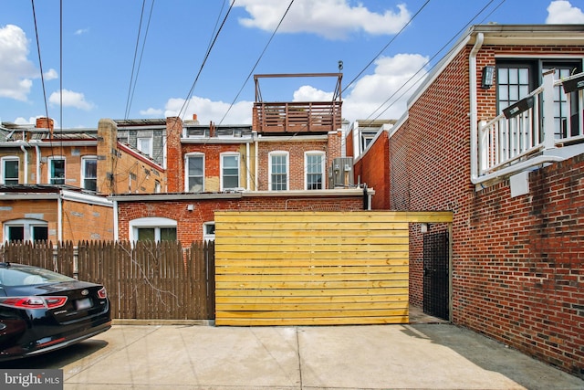 1240 Girard St NW, Washington, DC 20009 - view of side of property featuring brick siding and a gate