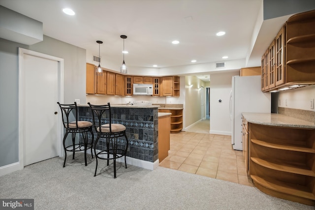 1240 Girard St NW, Washington, DC 20009 - kitchen with open shelves, white appliances, a peninsula, brown cabinetry, and a breakfast bar area