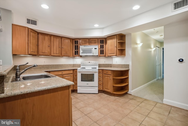 1240 Girard St NW, Washington, DC 20009 - kitchen featuring white appliances, open shelves, brown cabinetry, light stone counters, and recessed lighting