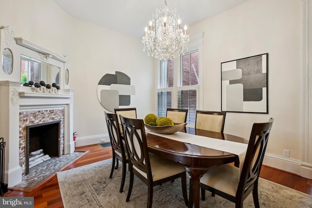 1240 Girard St NW, Washington, DC 20009 - dining space with a chandelier, wood finished floors, and a tiled fireplace