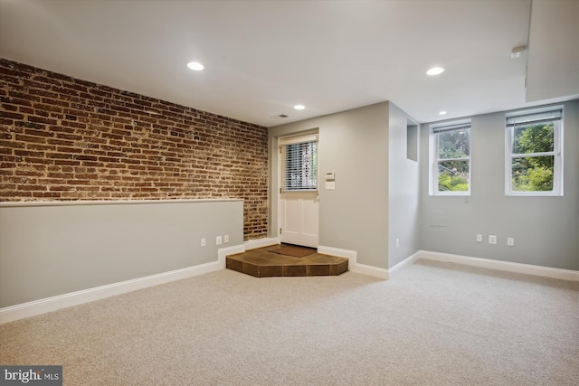 1240 Girard St NW, Washington, DC 20009 - carpeted foyer entrance featuring brick wall, recessed lighting, and healthy amount of natural light
