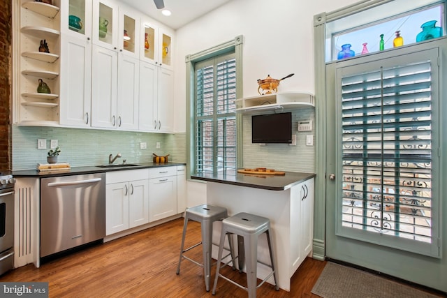 1240 Girard St NW, Washington, DC 20009 - kitchen featuring appliances with stainless steel finishes, dark countertops, open shelves, white cabinetry, and plenty of natural light