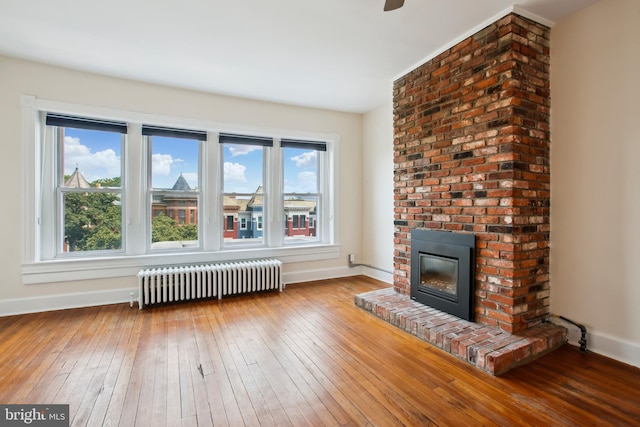 1240 Girard St NW, Washington, DC 20009 - living room with radiator, a fireplace, plenty of natural light, and wood-type flooring