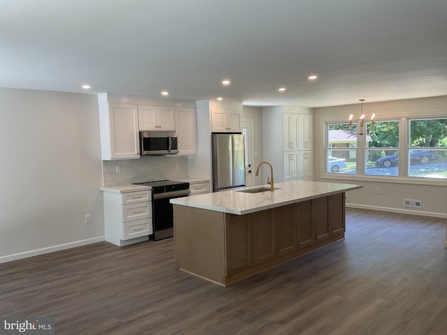 7804 Alberta Ct, Springfield, VA 22152 - kitchen with stainless steel appliances, dark wood finished floors, white cabinets, a chandelier, and tasteful backsplash