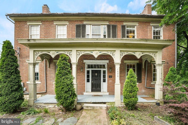 1498 Mckinstrys Mill Rd, Union Bridge, MD 21791 - view of front facade featuring a porch, a chimney, and brick siding