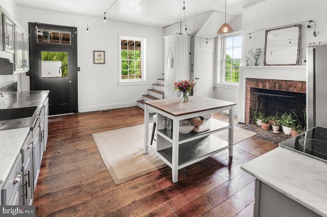 1498 Mckinstrys Mill Rd, Union Bridge, MD 21791 - kitchen featuring dark wood-style flooring, a fireplace, light countertops, pendant lighting, and stovetop