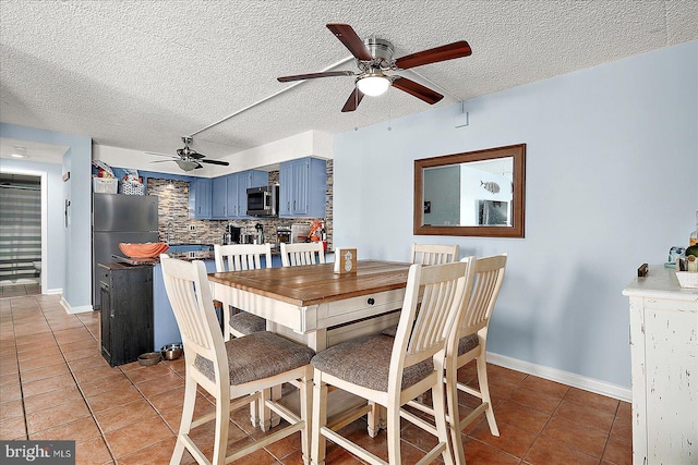 14 136th St Unit 101, Ocean City, MD 21842 - dining area with light tile patterned floors, ceiling fan, and a textured ceiling