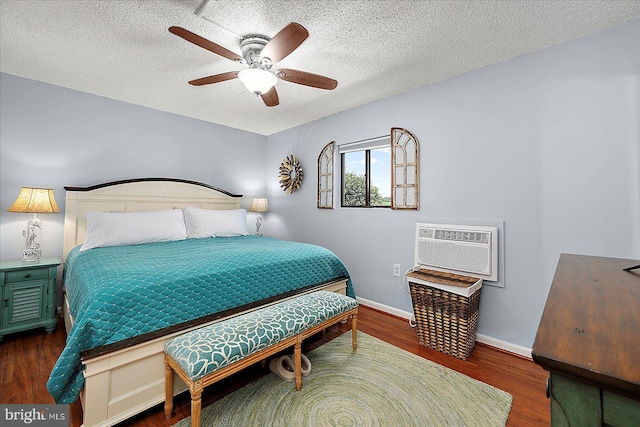 14 136th St Unit 101, Ocean City, MD 21842 - bedroom with wood finished floors, a wall unit AC, a textured ceiling, and ceiling fan