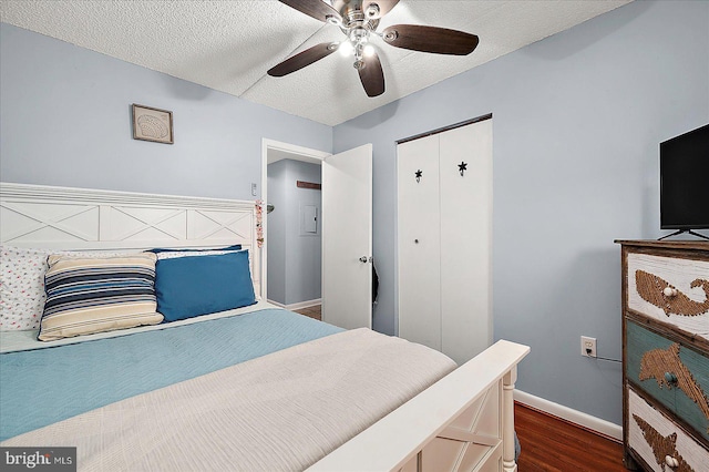 14 136th St Unit 101, Ocean City, MD 21842 - bedroom with dark wood-type flooring, a closet, a textured ceiling, and a ceiling fan