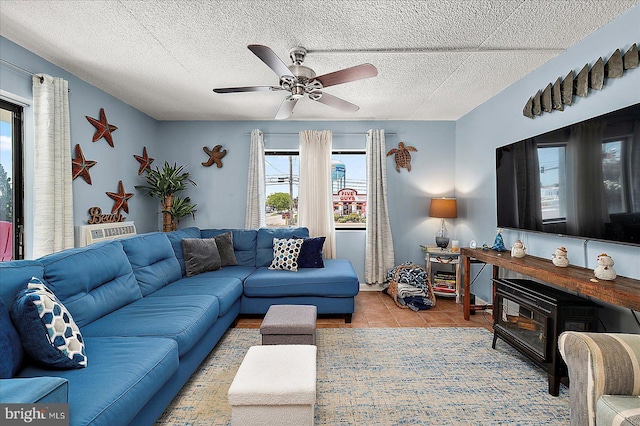 14 136th St Unit 101, Ocean City, MD 21842 - tiled living room featuring a ceiling fan and a textured ceiling