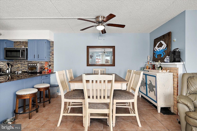 14 136th St Unit 101, Ocean City, MD 21842 - dining area featuring ceiling fan, light tile patterned floors, and a textured ceiling