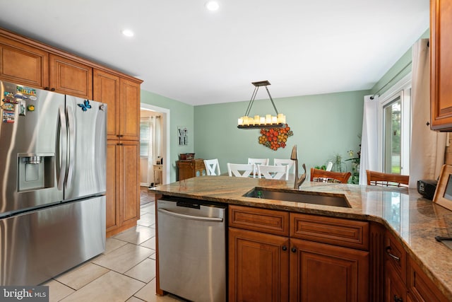 478 Alexander Ave, Maple Shade, NJ 08052 - kitchen with stainless steel appliances, brown cabinets, a peninsula, a chandelier, and pendant lighting