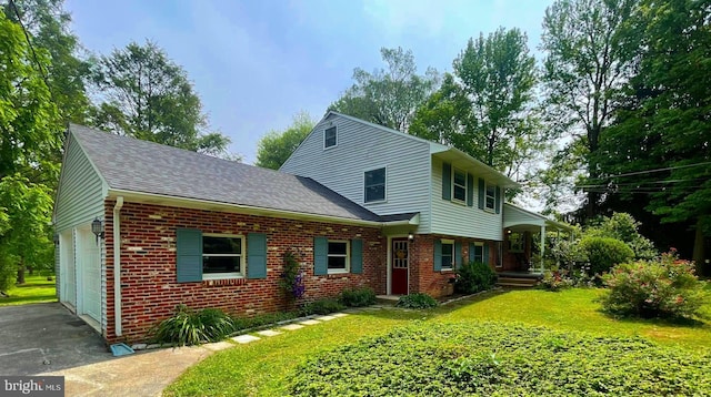 21 Long Ln, Malvern, PA 19355 - view of front facade featuring brick siding, roof with shingles, an attached garage, driveway, and a front yard