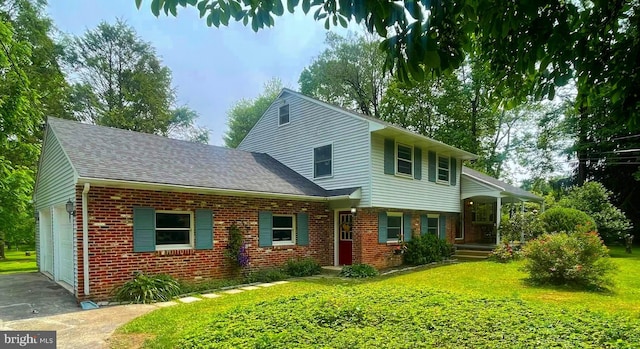21 Long Ln, Malvern, PA 19355 - view of front of home featuring brick siding, a garage, a front lawn, and a shingled roof