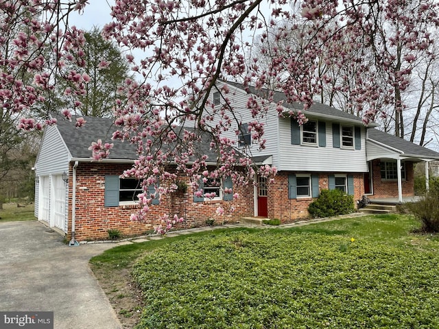 21 Long Ln, Malvern, PA 19355 - view of front facade featuring brick siding, a shingled roof, driveway, a front lawn, and a garage