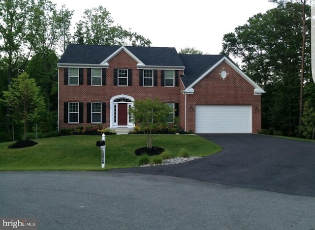 8304 Cedarview Ct, Clinton, MD 20735 - colonial house with brick siding, asphalt driveway, a garage, and a front lawn