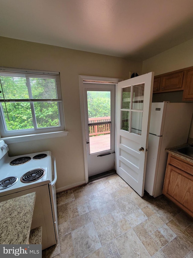 142 Fleetwood Ter, Silver Spring, MD 20910 - kitchen featuring white appliances, healthy amount of natural light, and stone finish flooring