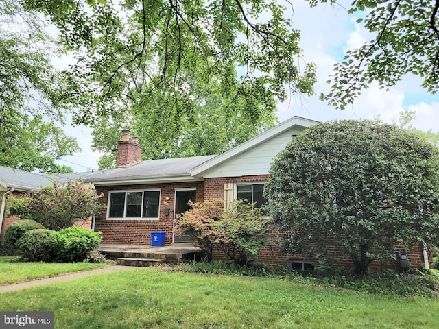 142 Fleetwood Ter, Silver Spring, MD 20910 - ranch-style house with brick siding, a front yard, and a chimney