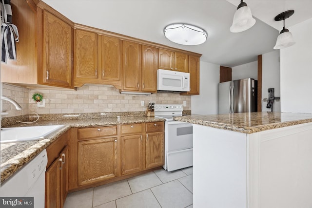 236 Lynn Rd, Ridley Park, PA 19078 - kitchen featuring white appliances, tasteful backsplash, light tile patterned flooring, brown cabinets, and light stone countertops
