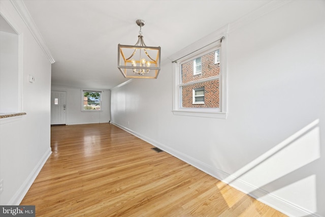 236 Lynn Rd, Ridley Park, PA 19078 - unfurnished dining area with a chandelier, ornamental molding, and light wood finished floors