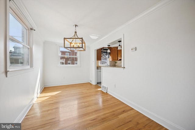 236 Lynn Rd, Ridley Park, PA 19078 - unfurnished dining area with a chandelier, crown molding, and light wood finished floors