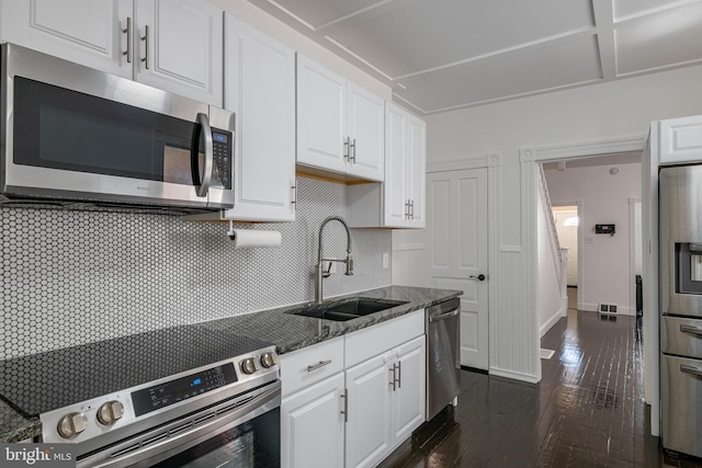 16 S 2nd St, Womelsdorf, PA 19567 - kitchen featuring stainless steel appliances, white cabinets, dark stone counters, tasteful backsplash, and dark wood-style floors