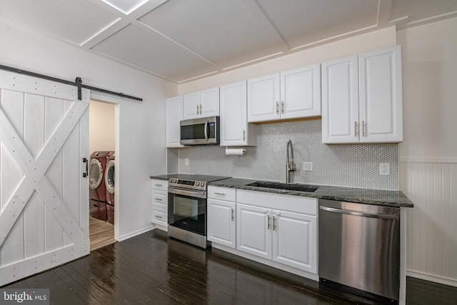16 S 2nd St, Womelsdorf, PA 19567 - kitchen featuring stainless steel appliances, washing machine and dryer, dark wood-style flooring, and white cabinets