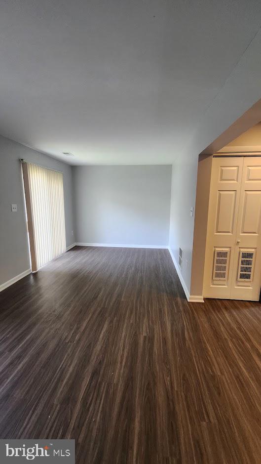 1756 Forest Park Dr, District Heights, MD 20747 - empty room with dark wood-type flooring and baseboards