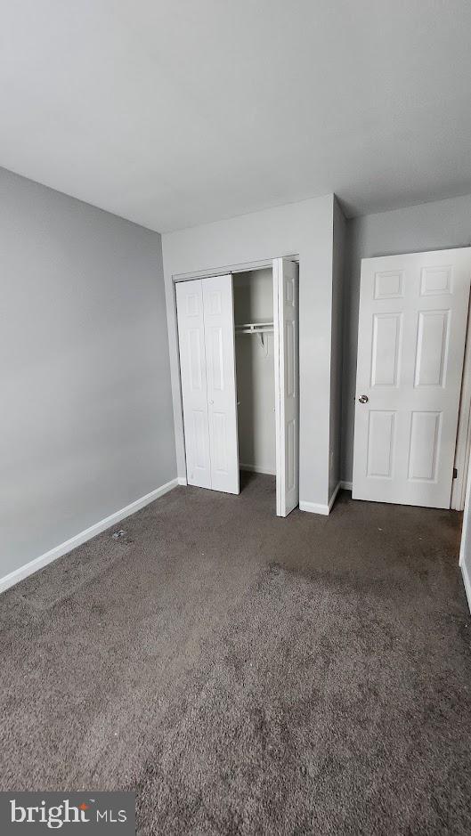 1756 Forest Park Dr, District Heights, MD 20747 - unfurnished bedroom with dark colored carpet and a closet