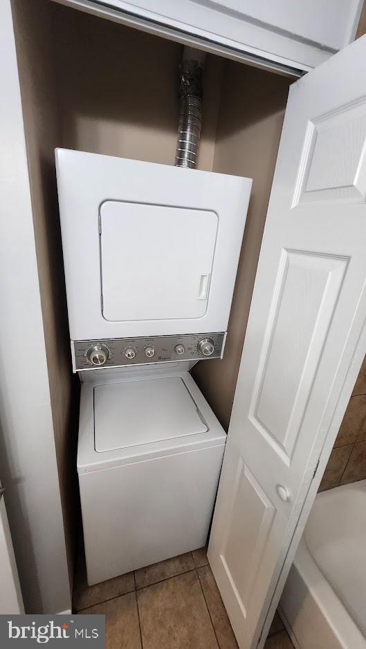 1756 Forest Park Dr, District Heights, MD 20747 - washroom with stacked washing machine and dryer and tile patterned floors