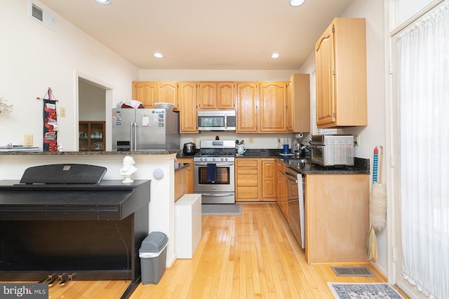 5819 Stream Pond Ct, Centreville, VA 20120 - kitchen featuring stainless steel appliances, light wood-style flooring, recessed lighting, and dark stone counters