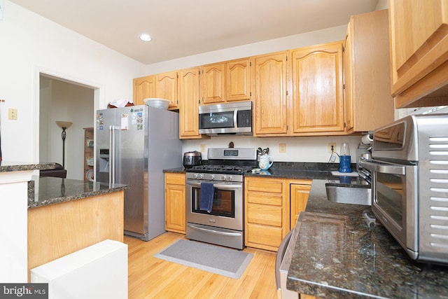 5819 Stream Pond Ct, Centreville, VA 20120 - kitchen with stainless steel appliances, light wood-type flooring, dark stone counters, light brown cabinetry, and recessed lighting