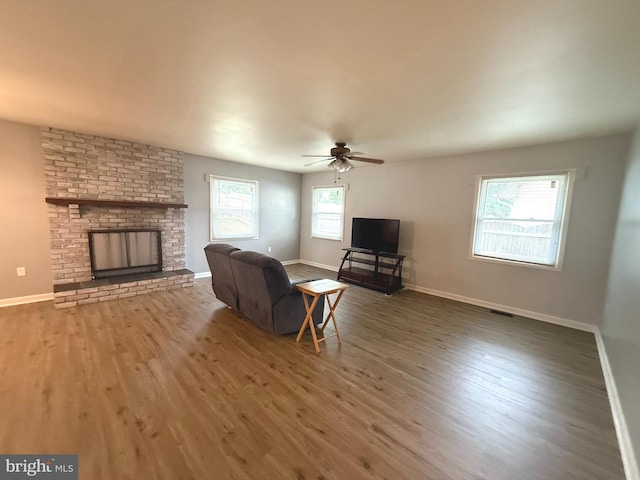 52 Henderson Ln, Willingboro, NJ 08046 - living room with wood finished floors, a brick fireplace, and a ceiling fan