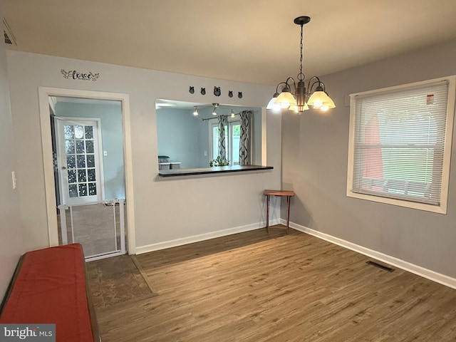 52 Henderson Ln, Willingboro, NJ 08046 - unfurnished dining area featuring wood finished floors and a chandelier