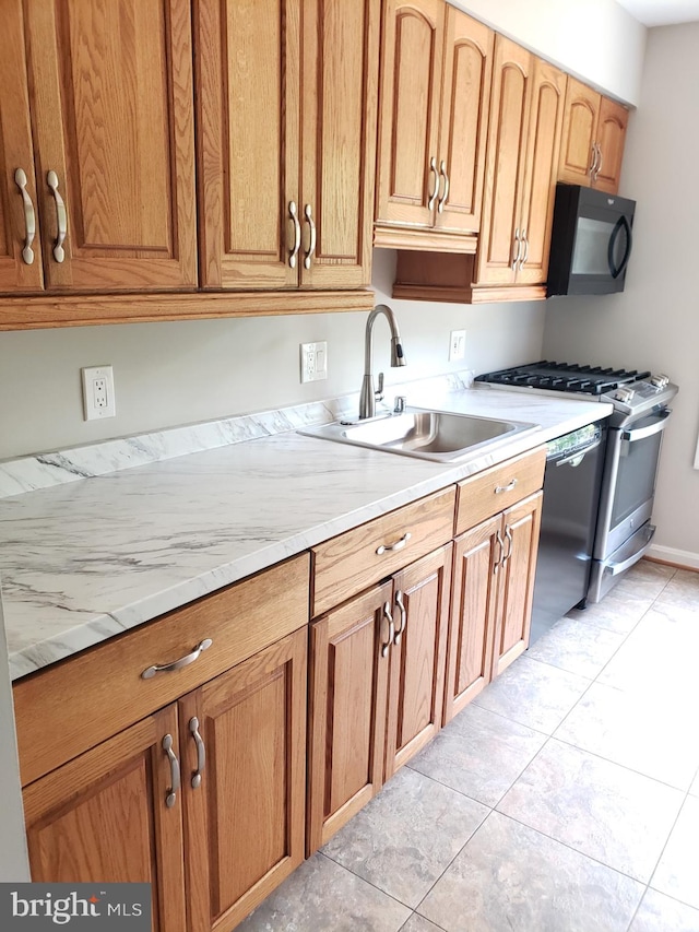 760 Princeton Pl Unit 1-760, Rockville, MD 20850 - kitchen with appliances with stainless steel finishes, light tile patterned floors, light stone counters, and brown cabinetry