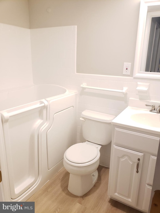760 Princeton Pl Unit 1-760, Rockville, MD 20850 - bathroom with wood finished floors, vanity, wainscoting, and tile walls