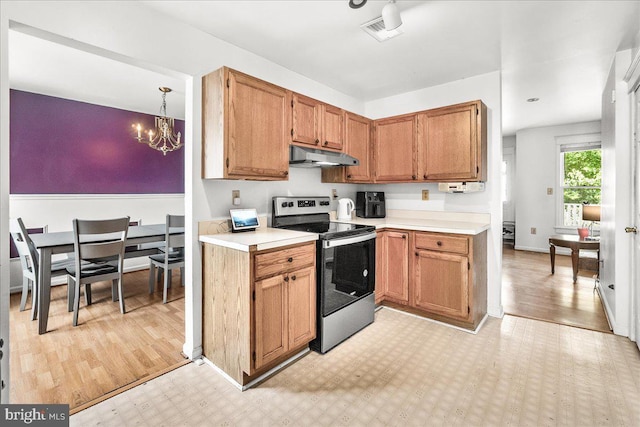 606 Knightsbridge Dr, Hagerstown, MD 21740 - kitchen with stainless steel range with electric cooktop, under cabinet range hood, a chandelier, and light countertops