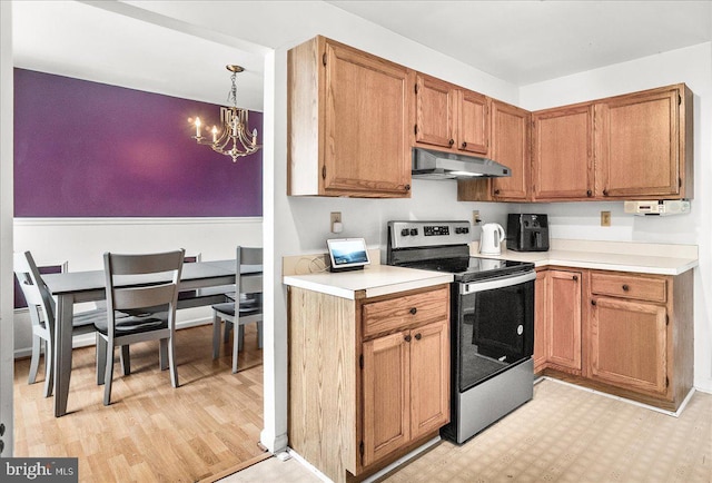 606 Knightsbridge Dr, Hagerstown, MD 21740 - kitchen with stainless steel range with electric stovetop, under cabinet range hood, a chandelier, light countertops, and light wood-type flooring