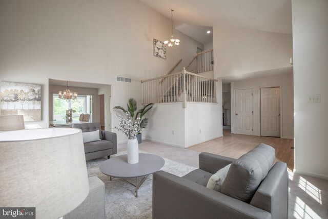 505 Country Pointe Cir, Perkasie, PA 18944 - living room featuring a chandelier, high vaulted ceiling, stairway, and carpet flooring