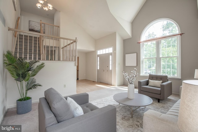 505 Country Pointe Cir, Perkasie, PA 18944 - living area with a chandelier, high vaulted ceiling, stairs, and carpet floors