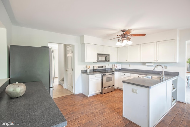 505 Country Pointe Cir, Perkasie, PA 18944 - kitchen with appliances with stainless steel finishes, white cabinets, a peninsula, and light wood-style floors