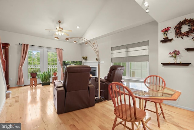 2044 Astilbe Way Unit 2044, Odenton, MD 21113 - dining space with ceiling fan, light wood-style flooring, lofted ceiling, a warm lit fireplace, and recessed lighting