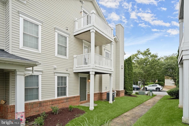 2044 Astilbe Way Unit 2044, Odenton, MD 21113 - view of property exterior featuring a balcony, a yard, and brick siding