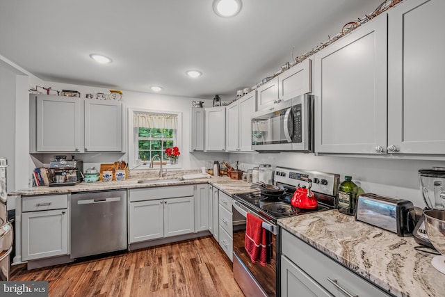 9434 Winchester Ave, Bunker Hill, WV 25413 - kitchen with stainless steel appliances, recessed lighting, light stone counters, and light wood-style floors