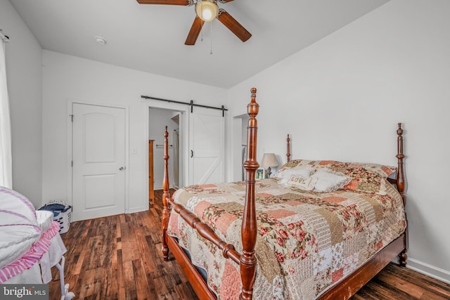 9434 Winchester Ave, Bunker Hill, WV 25413 - bedroom with wood finished floors, a barn door, and a ceiling fan