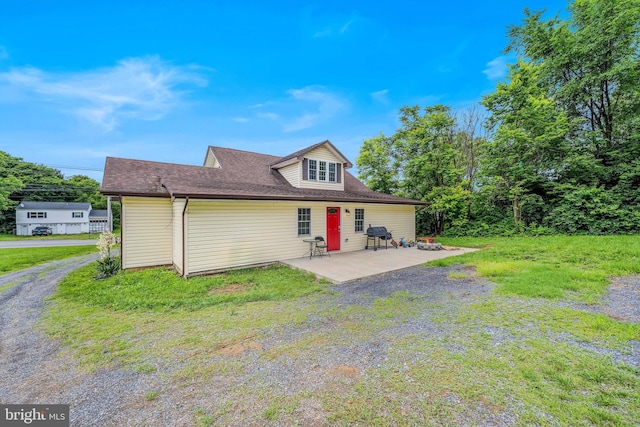 9434 Winchester Ave, Bunker Hill, WV 25413 - rear view of property with a patio and a lawn