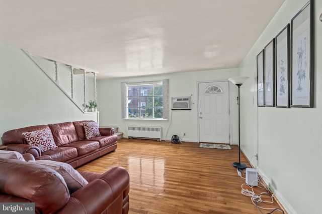 1329 Barnett St, Philadelphia, PA 19111 - living room with radiator heating unit, wood finished floors, a wall mounted air conditioner, and stairs