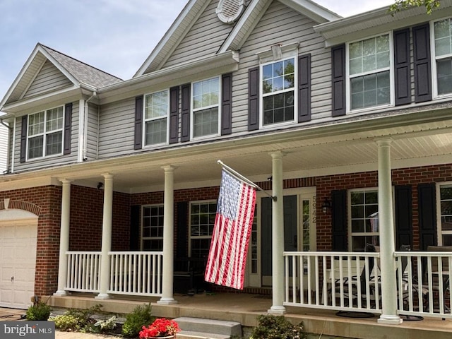 5942 Fincastle Dr, Manassas, VA 20112 - townhome / multi-family property featuring covered porch, brick siding, and an attached garage